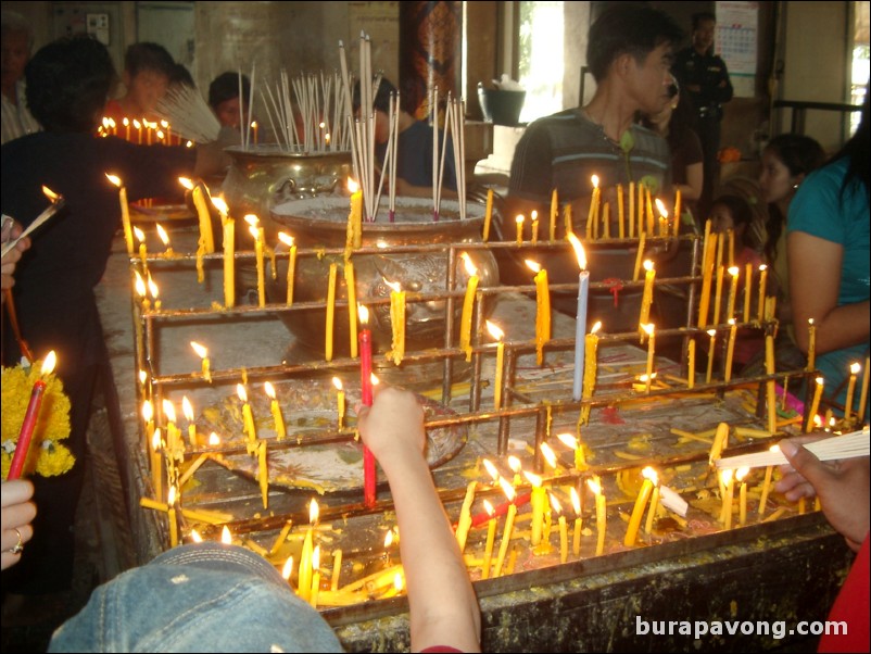 Candles lit for worship, Wat Phananchoeng.