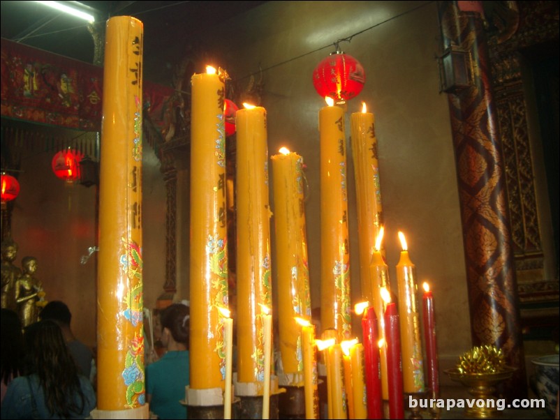 Candles lit for worship, Wat Phananchoeng.