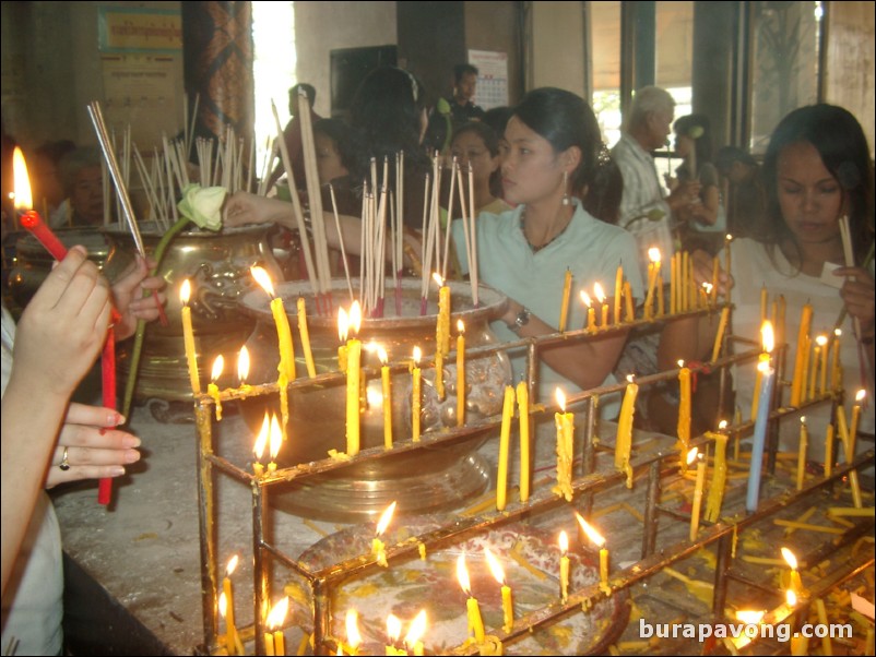 People using candles to worship, Wat Phananchoeng.