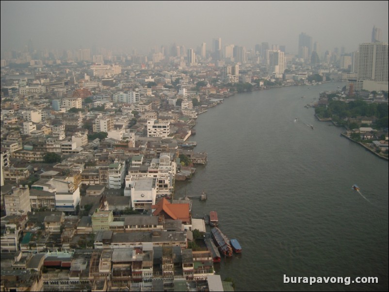 Afternoon skyline views of Bangkok from Samphanthawong. Chao Phraya River below.