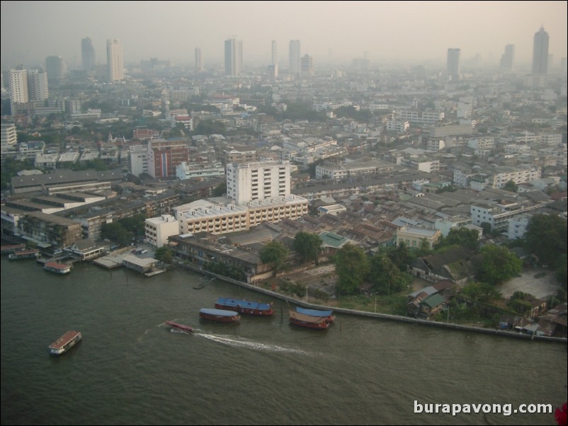 Afternoon skyline views of Bangkok from Samphanthawong. Chao Phraya River below.