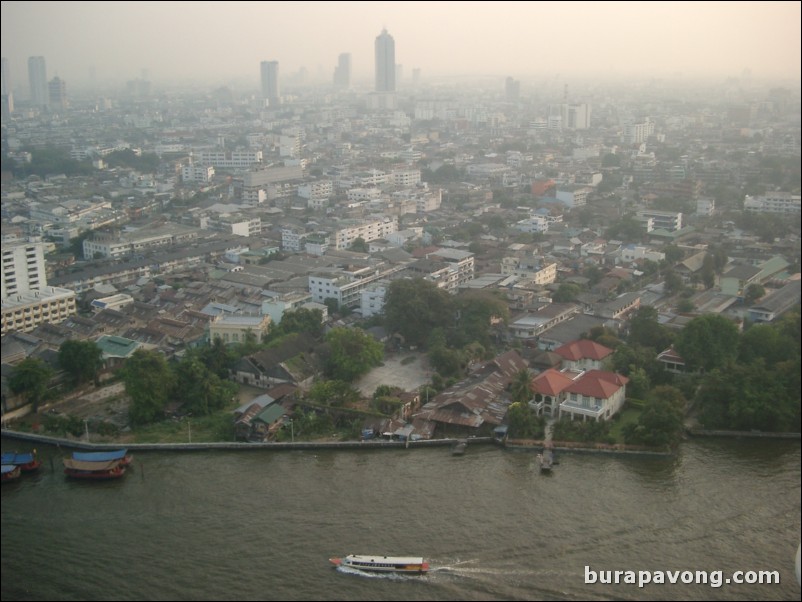 Afternoon skyline views of Bangkok from Samphanthawong. Chao Phraya River below.