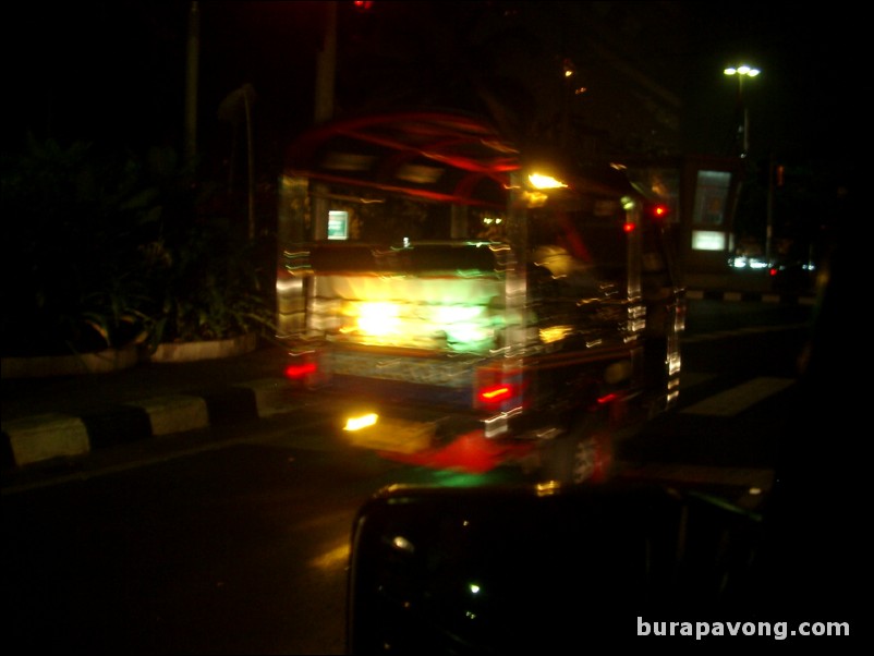 Back of a tuk-tuk at night.