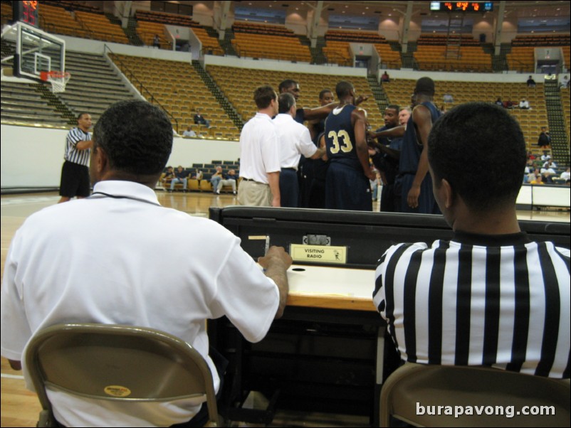 Coach Hewitt watching the scrimmage from the scorer's table.