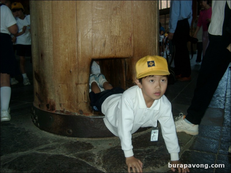 School kids crawling through a hole for enlightenment, Todai-ji Temple.