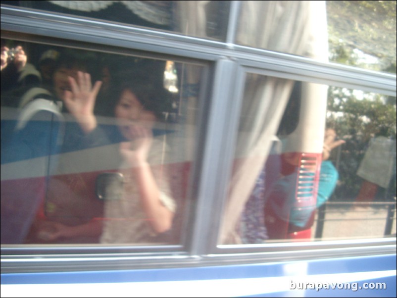 Girls waving from a bus on the way to Osaka Castle.